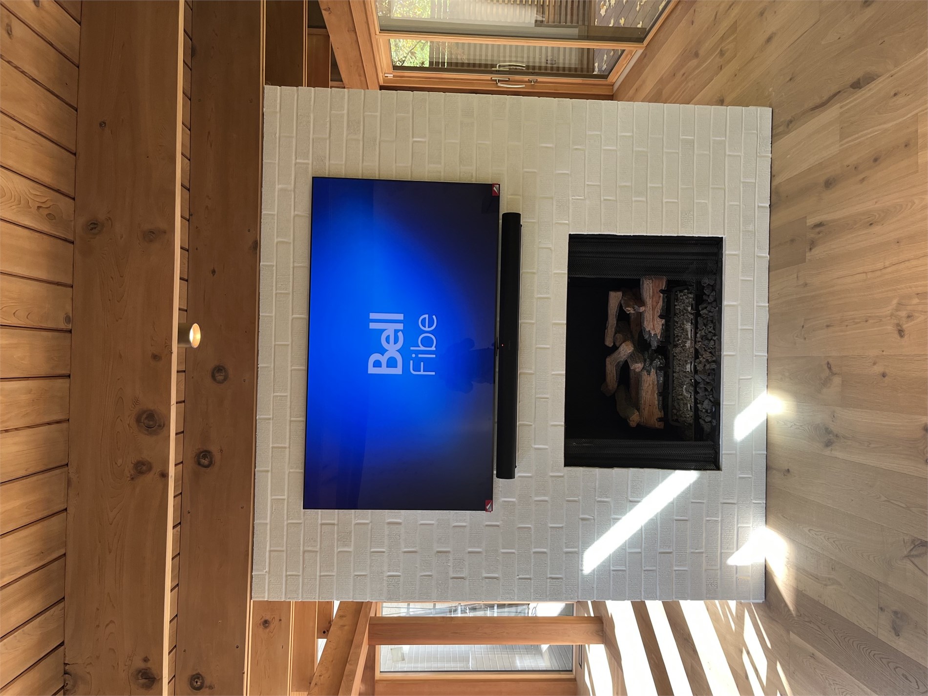 TV and soundbar over fireplace